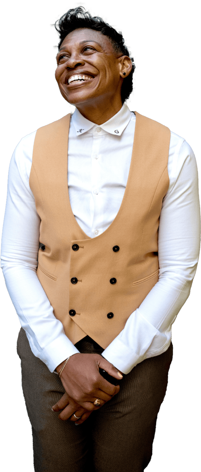 Khaliah O. Guillory smiling, in a camel vest